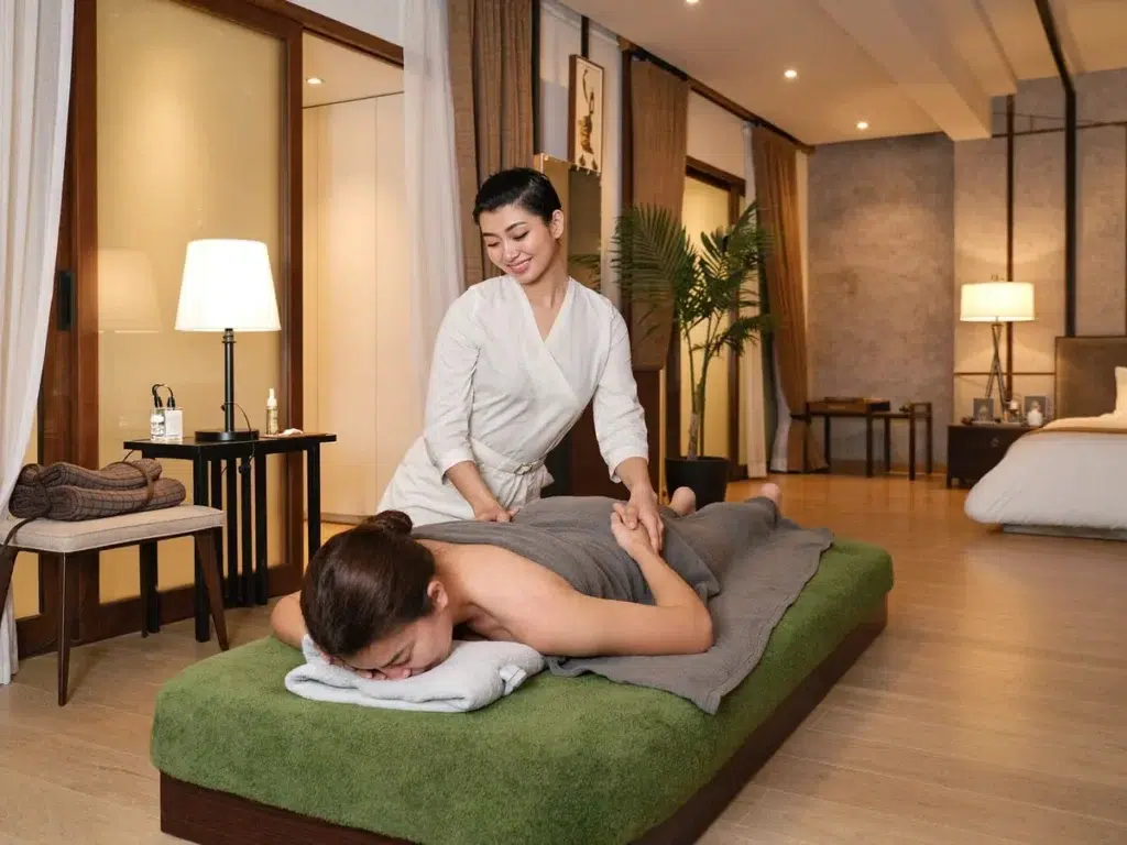 Outcall Massage for Digital Nomads in Thailand: Stay Balanced A relaxing Thai massage in a modern Bangkok condo, the therapist working on a draped client