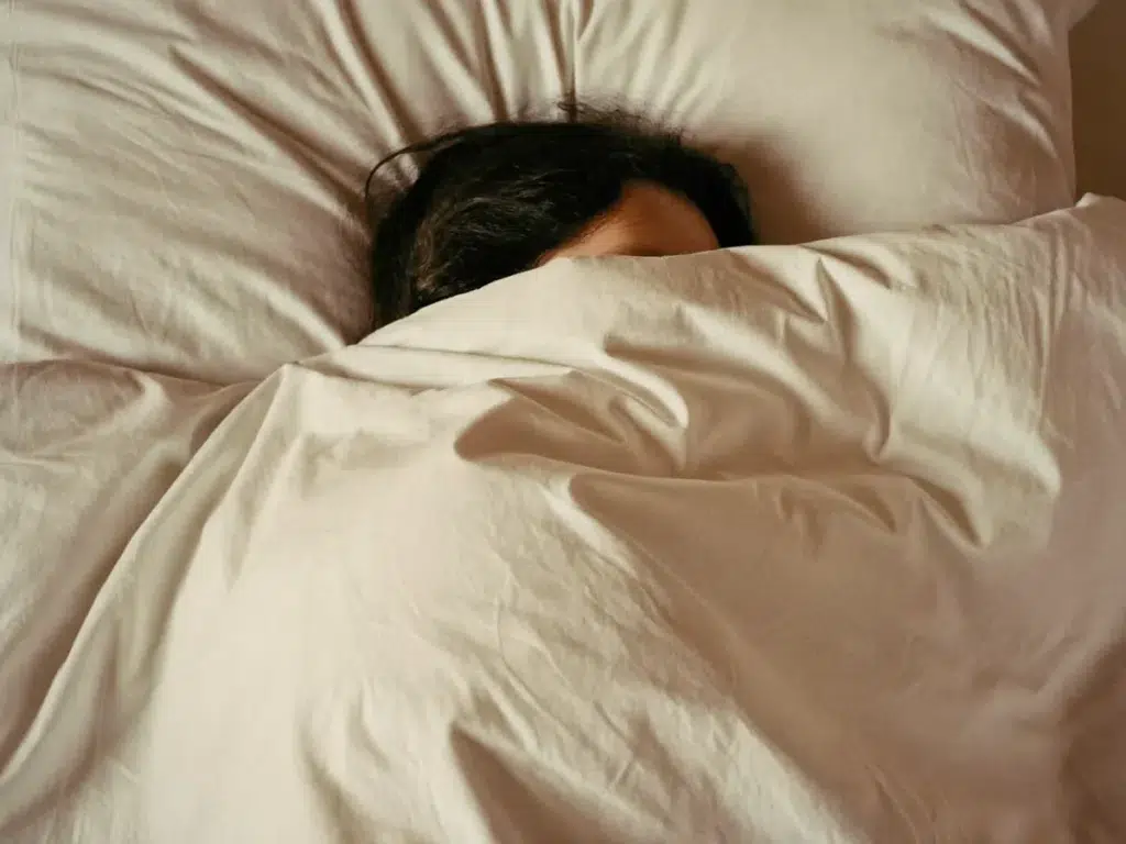 Touch as Medicine: The Science Behind Traditional Thai Massage A person resting peacefully and deeply relaxed after a massage in a calm room