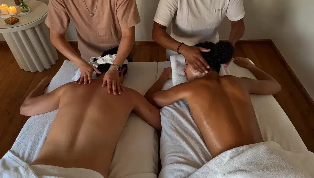 Couples Massage in Bangkok: Planning a Romantic In-Room Experience A couples massage in a Bangkok hotel room, two therapists working on a couple side by side